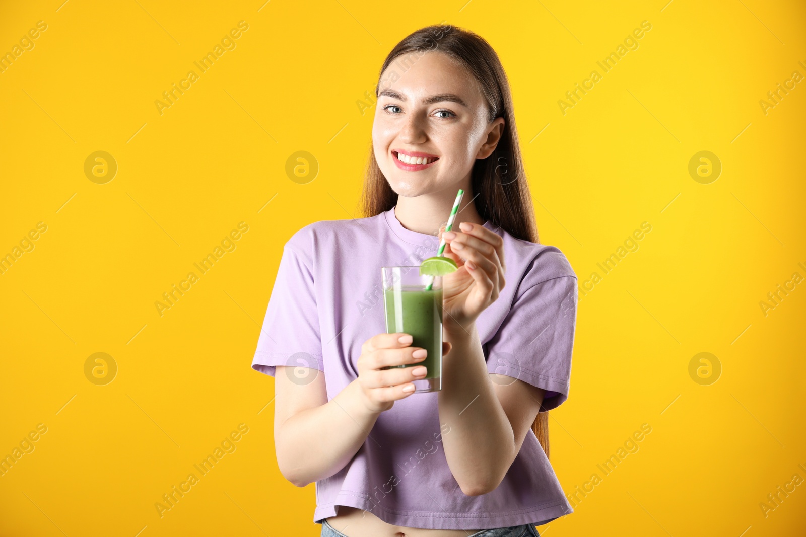 Photo of Woman with refreshing drink and straw on orange background
