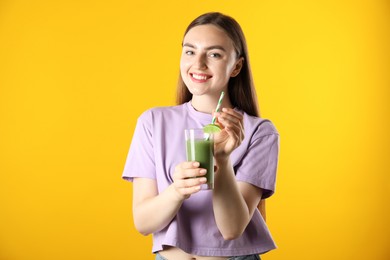Photo of Woman with refreshing drink and straw on orange background