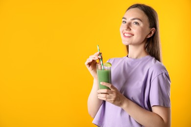 Photo of Woman with refreshing drink and straw on orange background, space for text