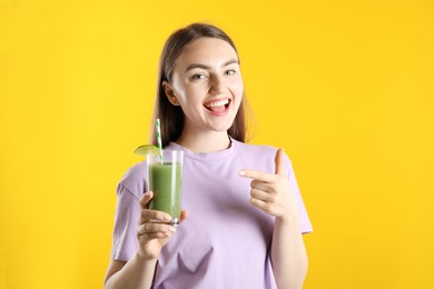 Photo of Woman with refreshing drink and straw on orange background