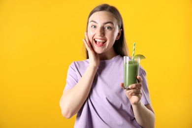 Photo of Woman with refreshing drink and straw on orange background
