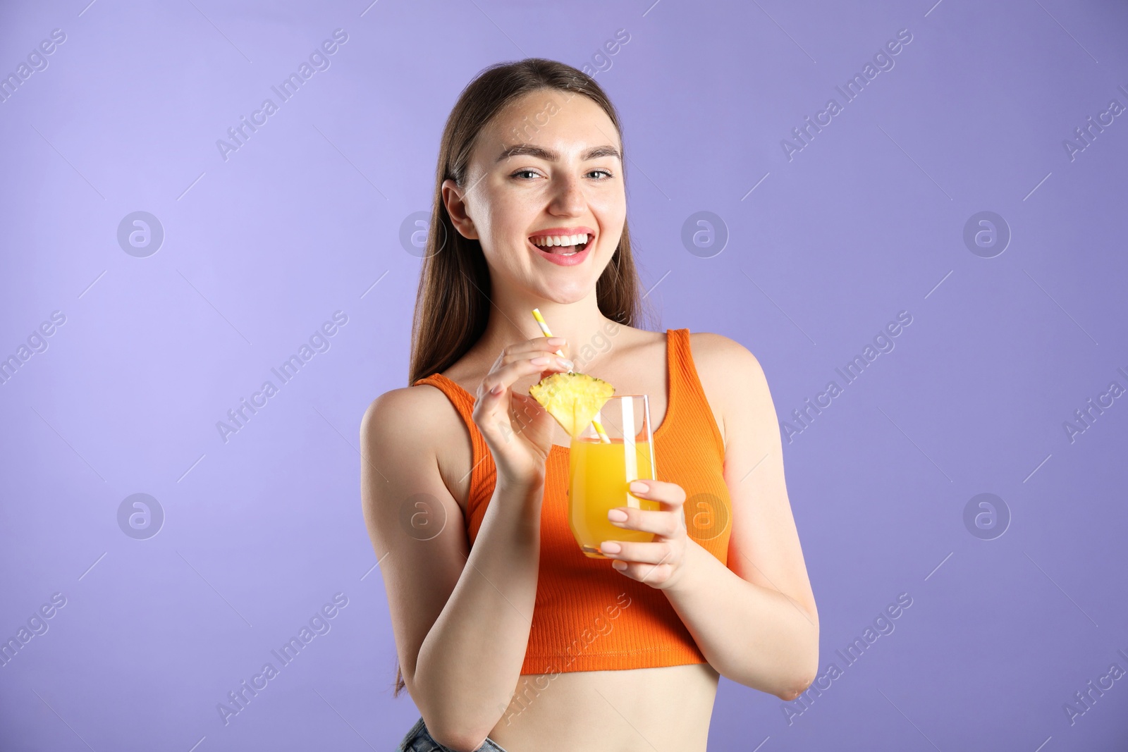 Photo of Woman with refreshing drink and straw on violet background