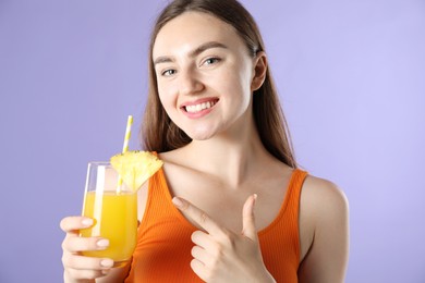 Photo of Woman with refreshing drink and straw on violet background
