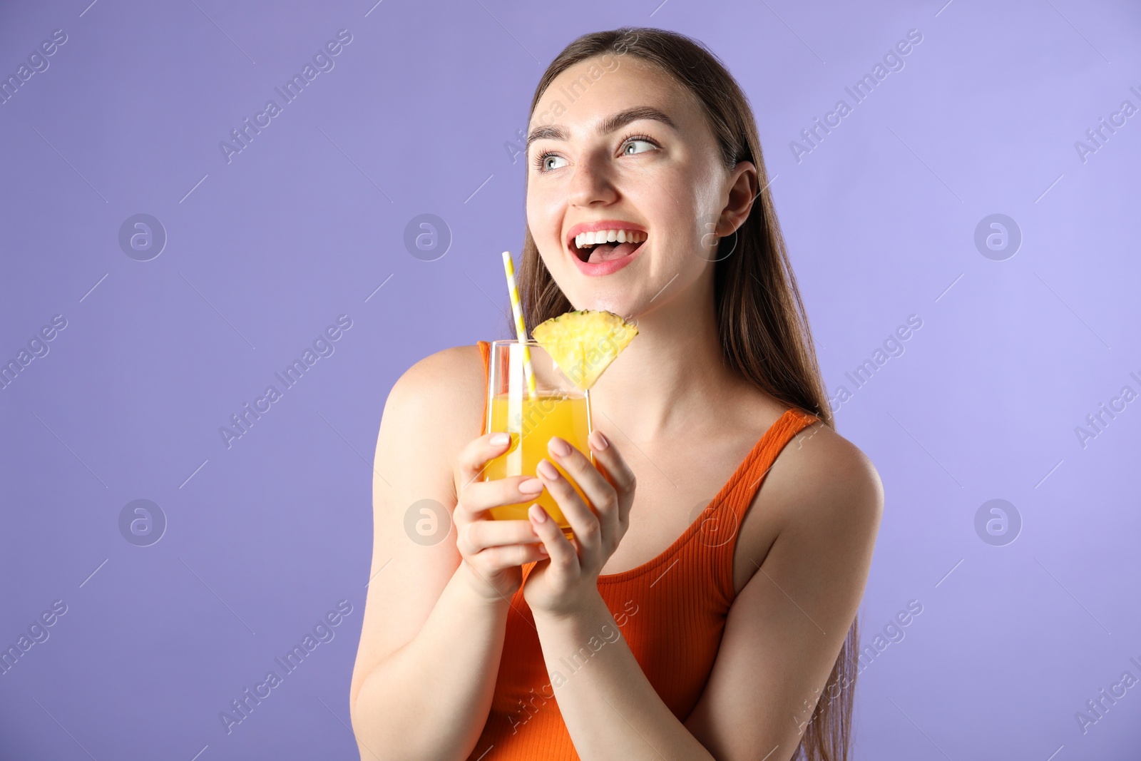 Photo of Woman with refreshing drink and straw on violet background