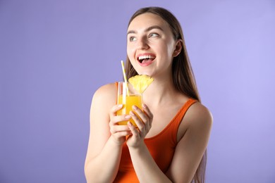 Photo of Woman with refreshing drink and straw on violet background