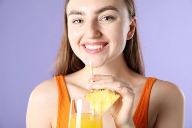 Photo of Woman with refreshing drink and straw on violet background