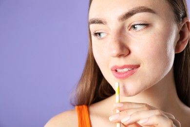 Photo of Woman with drinking straw on violet background, space for text