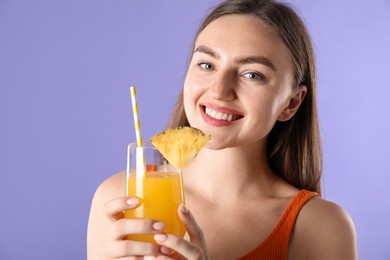 Photo of Woman with refreshing drink and straw on violet background