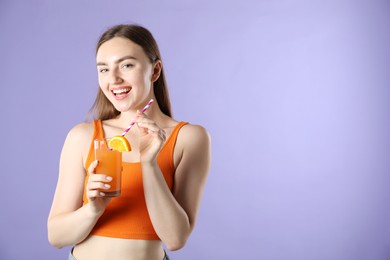 Photo of Woman with refreshing drink and straw on violet background, space for text