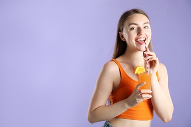 Photo of Woman with refreshing drink and straw on violet background, space for text