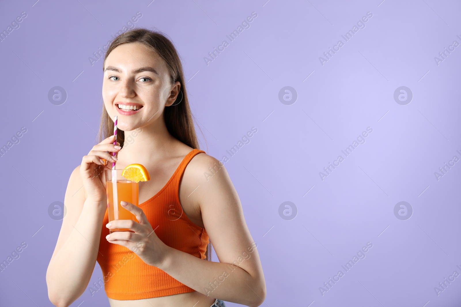 Photo of Woman with refreshing drink and straw on violet background, space for text
