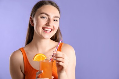 Photo of Woman with refreshing drink and straw on violet background, space for text