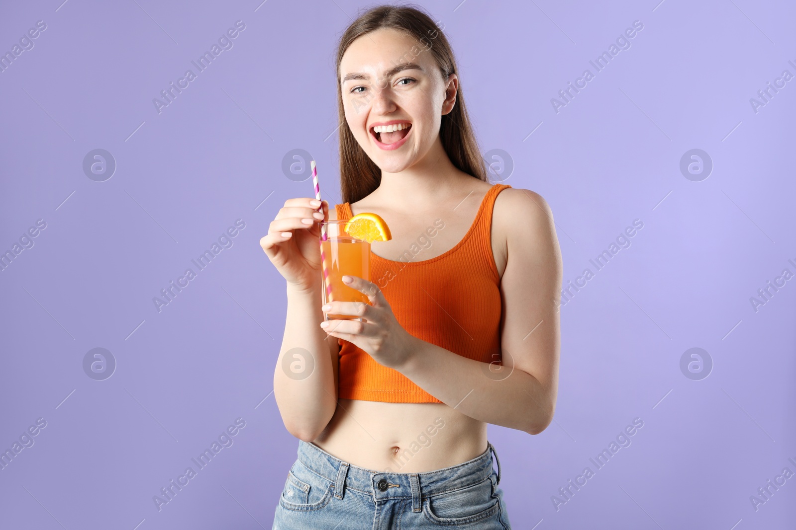 Photo of Woman with refreshing drink and straw on violet background
