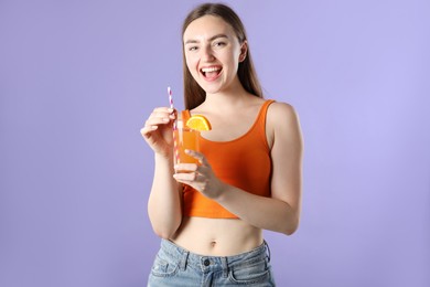 Photo of Woman with refreshing drink and straw on violet background
