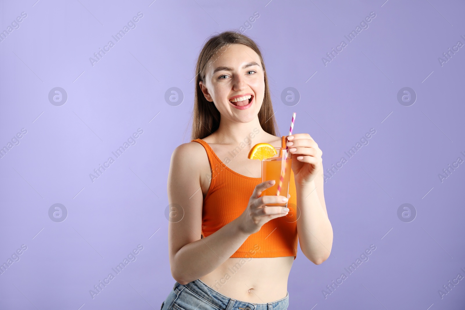 Photo of Woman with refreshing drink and straw on violet background
