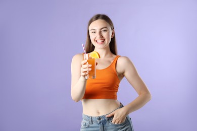 Photo of Woman with refreshing drink and straw on violet background
