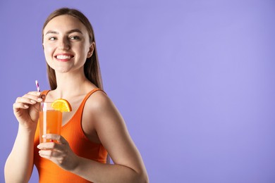 Photo of Woman with refreshing drink and straw on violet background, space for text
