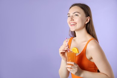 Photo of Woman with refreshing drink and straw on violet background, space for text
