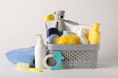 Photo of Baby accessories and body care products on light grey background