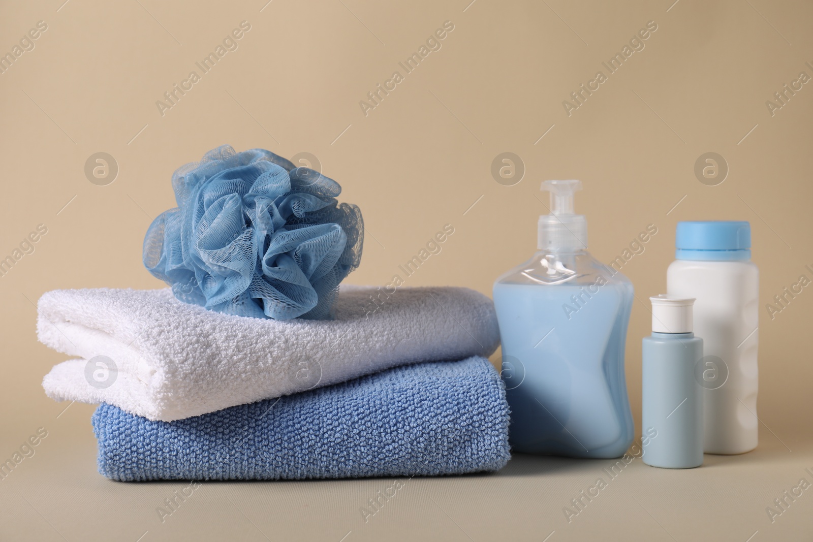 Photo of Baby accessories and body care products on beige background
