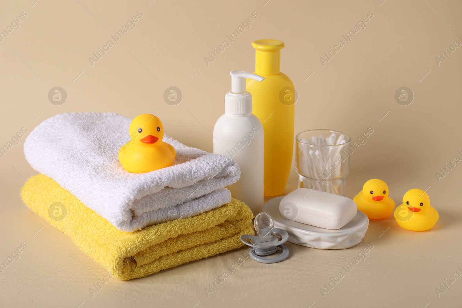 Photo of Baby accessories and body care products on beige background