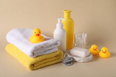 Photo of Baby accessories and body care products on beige background