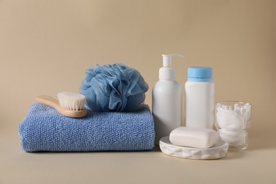 Photo of Baby accessories and body care products on beige background