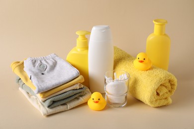 Photo of Baby accessories, clothes and body care products on beige background