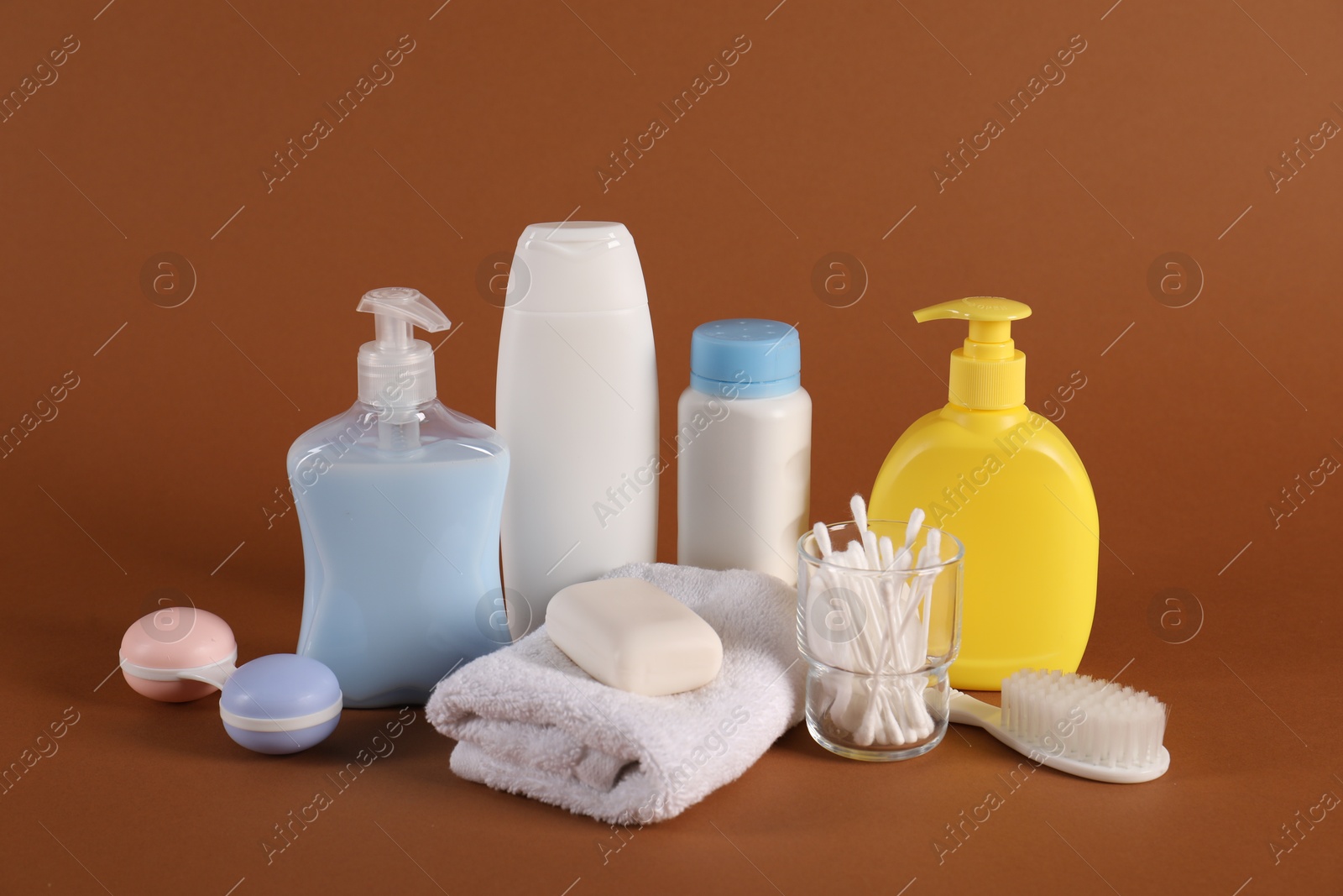 Photo of Baby accessories and body care products on brown background