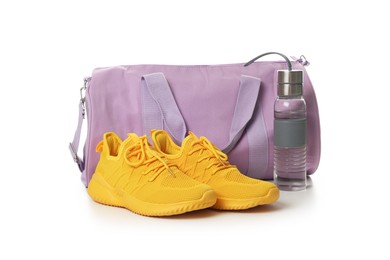 Photo of Stylish sports bag, bottle and sneakers isolated on white