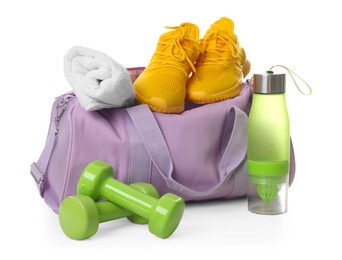 Photo of Stylish sports bag with sneakers, towel, bottle and dumbbells isolated on white