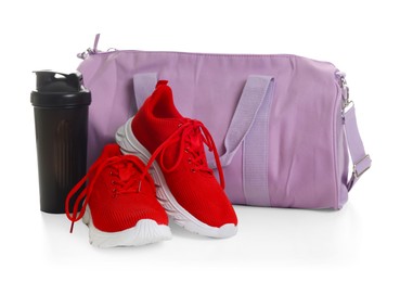 Photo of Stylish sports bag, sneakers and shaker cup isolated on white