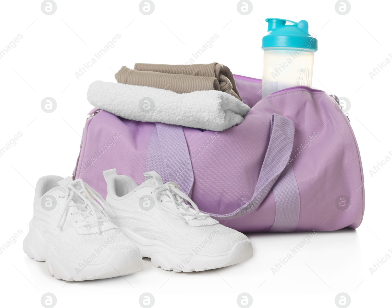 Photo of Stylish sports bag with shaker cup, clothes and sneakers isolated on white