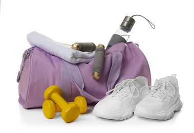 Photo of Stylish gym bag with sports equipment, towel, bottle and sneakers isolated on white