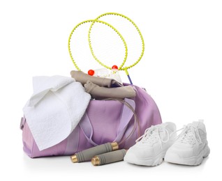 Photo of Stylish gym bag with sports equipment, towel and sneakers isolated on white