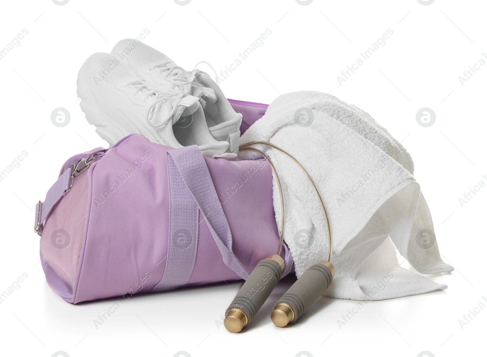 Photo of Stylish sports bag with sneakers, towel and skipping rope isolated on white