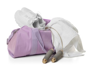 Photo of Stylish sports bag with sneakers, towel and skipping rope isolated on white
