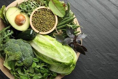 Photo of Superfood. Healthy food products in bowl on black table, top view. Space for text