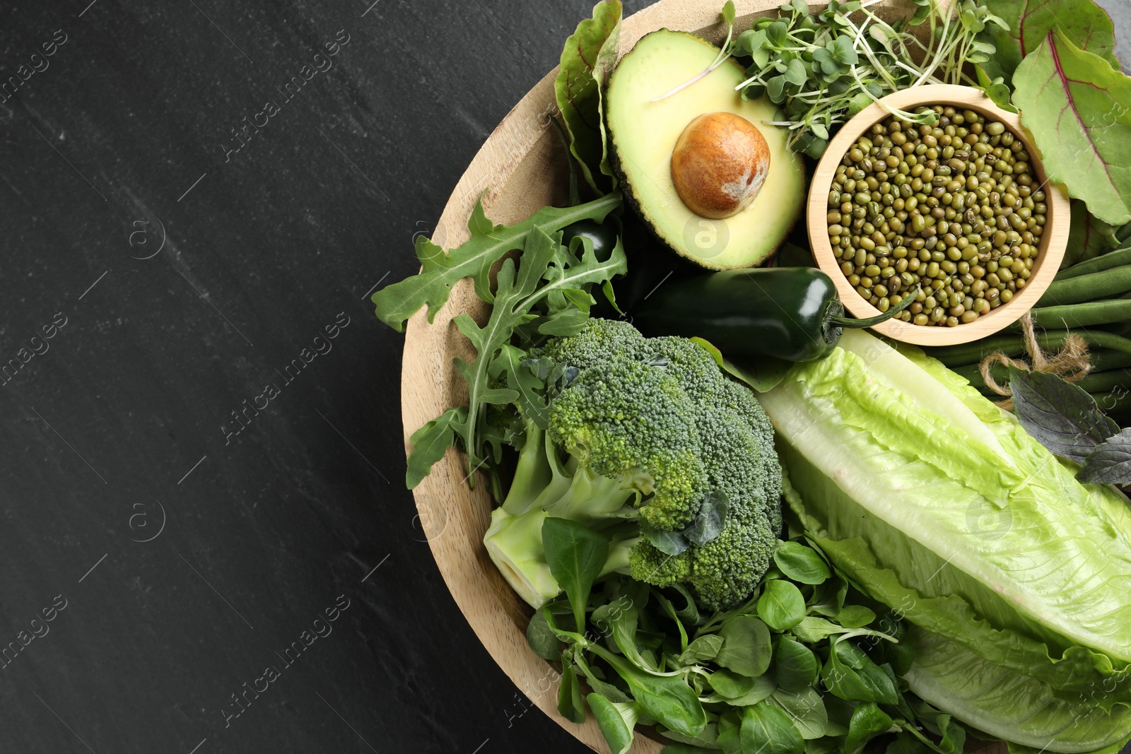 Superfood. Healthy food products in bowl on black table, top view. Space for text Photo of Superfood. Healthy food products in bowl on black table, top view. Space for text