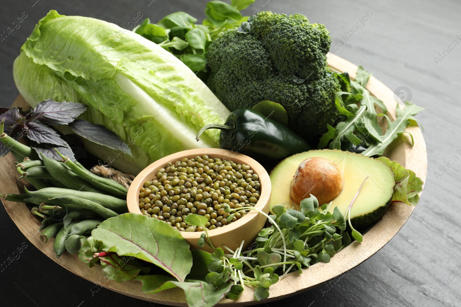 Superfood. Healthy food products in bowl on black table, closeup Photo of Superfood. Healthy food products in bowl on black table, closeup