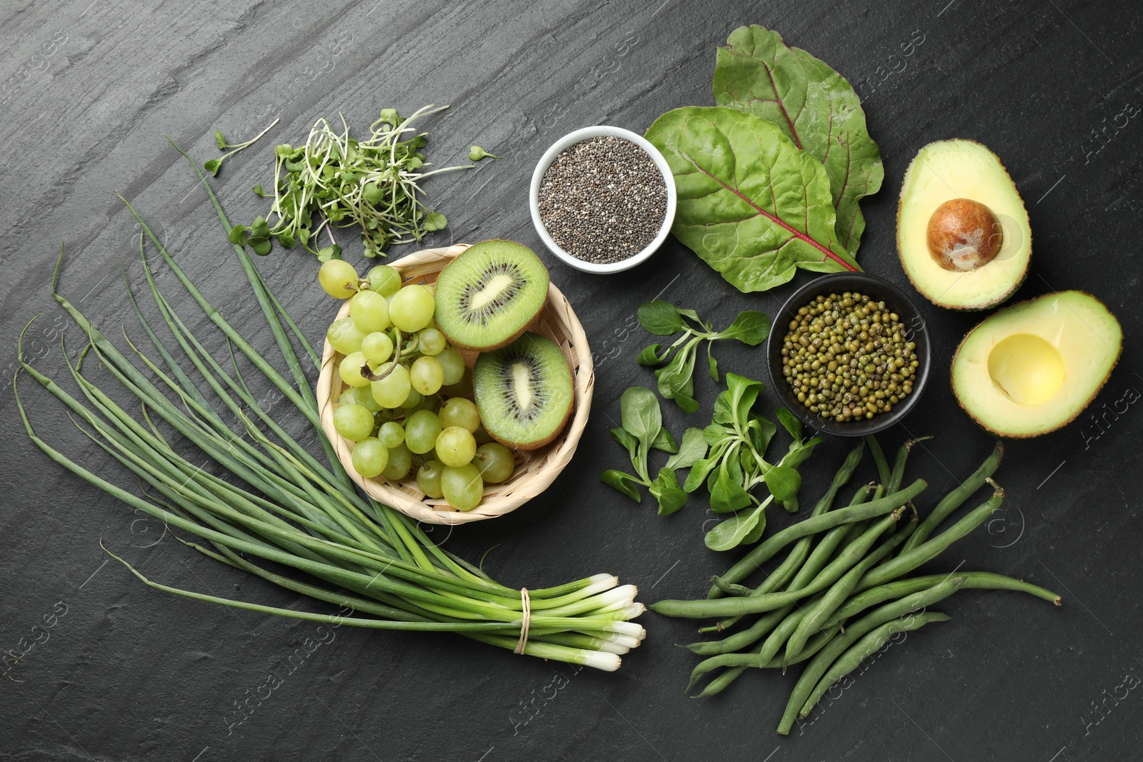 Superfood. Healthy food products on black table, flat lay Photo of Superfood. Healthy food products on black table, flat lay