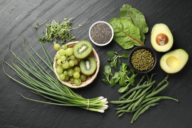 Photo of Superfood. Healthy food products on black table, flat lay