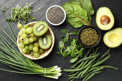 Photo of Superfood. Healthy food products on black table, flat lay