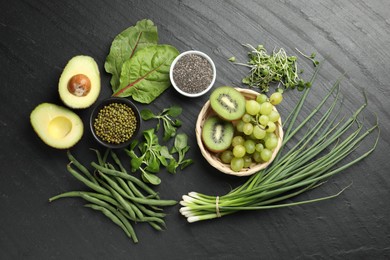 Photo of Superfood. Healthy food products on black table, flat lay