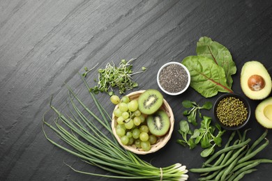 Photo of Superfood. Healthy food products on black table, flat lay. Space for text