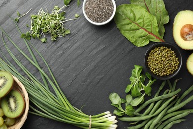 Photo of Superfood. Healthy food products on black table, flat lay. Space for text