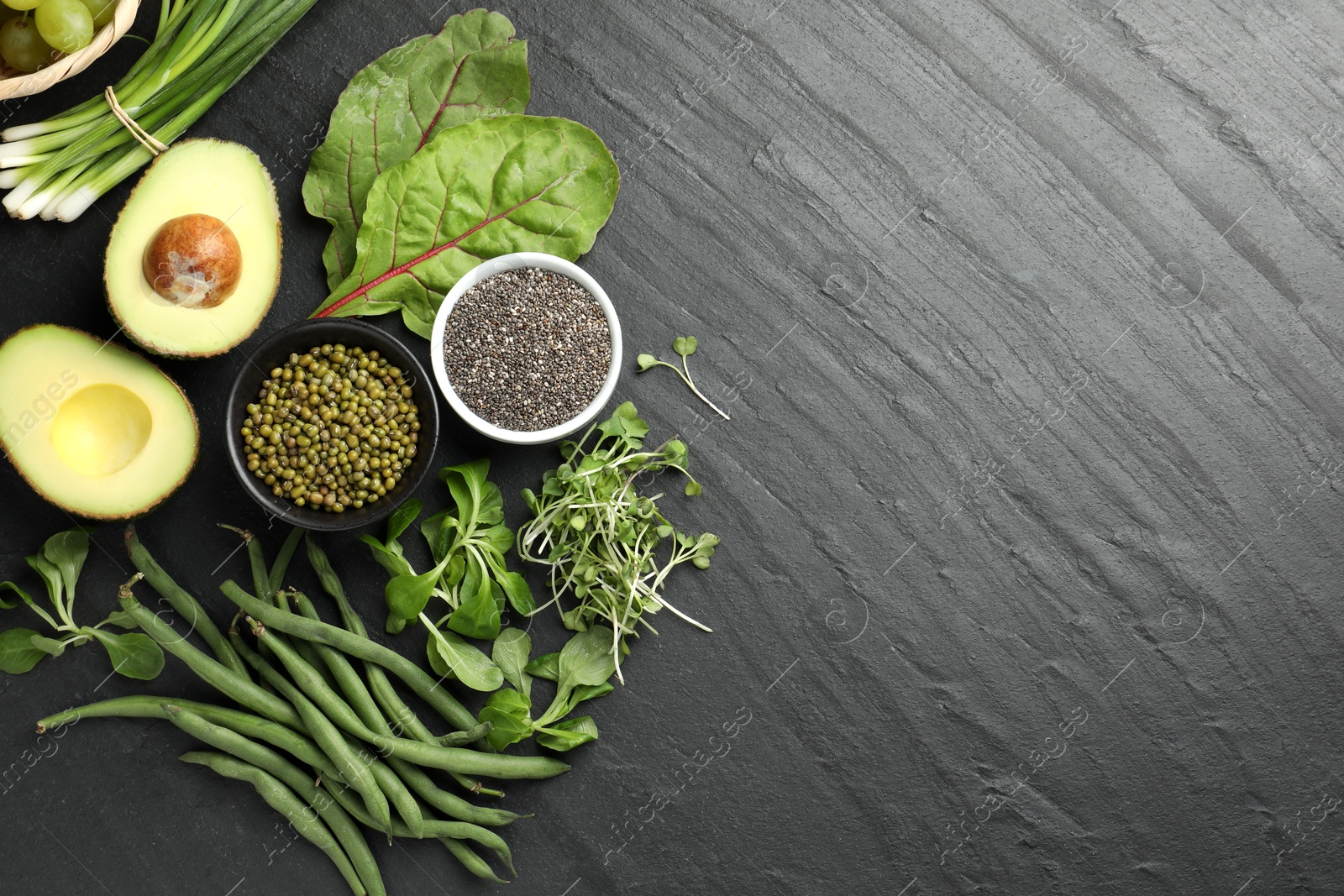Superfood. Healthy food products on black table, flat lay. Space for text Photo of Superfood. Healthy food products on black table, flat lay. Space for text