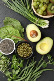Photo of Superfood. Healthy food products on black table, flat lay