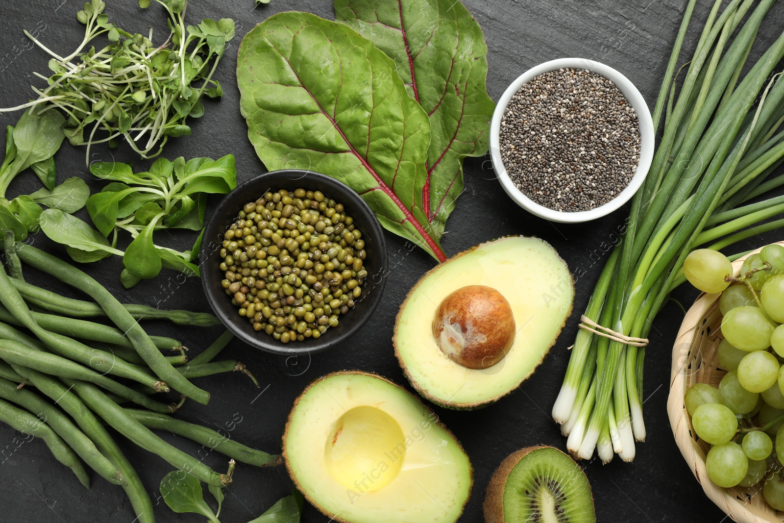 Superfood. Healthy food products on black table, flat lay Photo of Superfood. Healthy food products on black table, flat lay