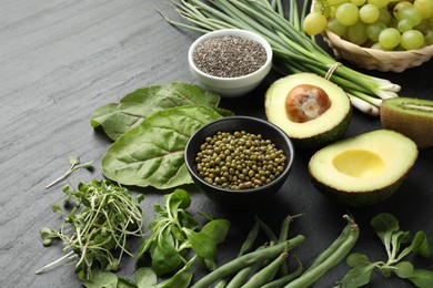 Photo of Superfood. Healthy food products on black table, closeup